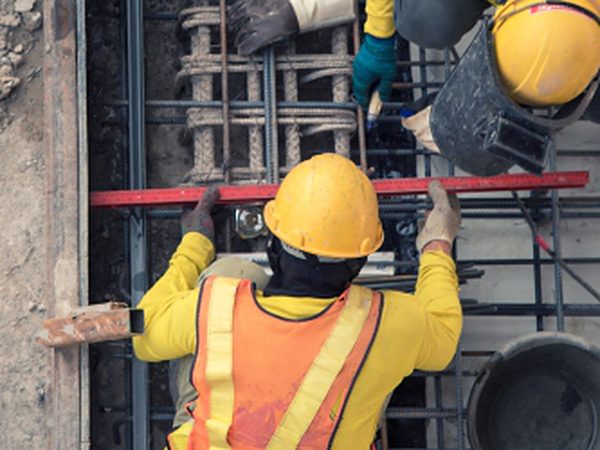 Workers fixing steel reinforcement for concrete